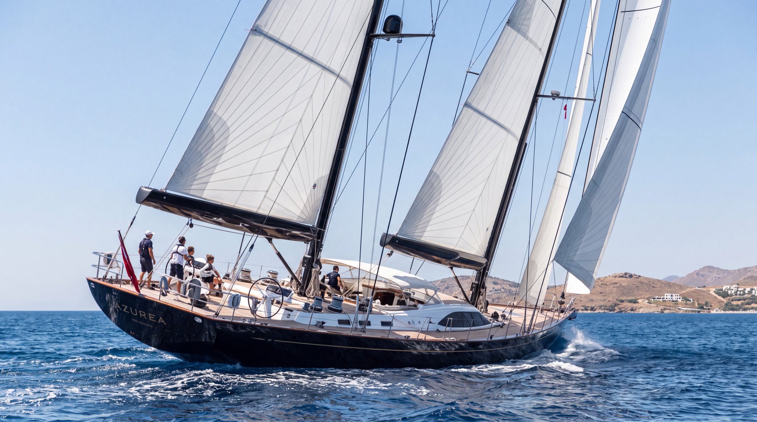 A large sailing superyacht under full sail off the Turkish coast